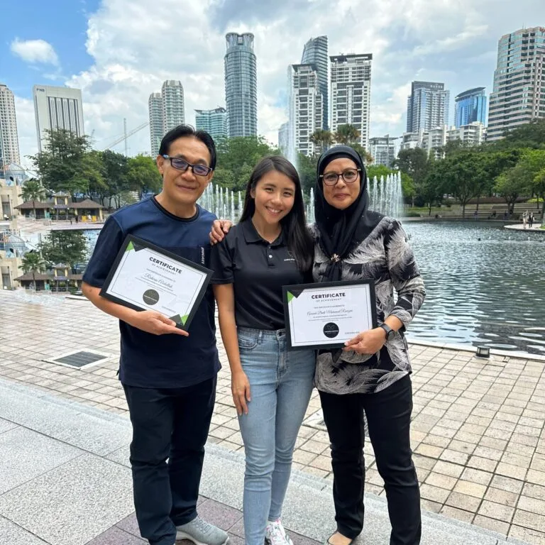 couple holding certificates with young lady in the middle