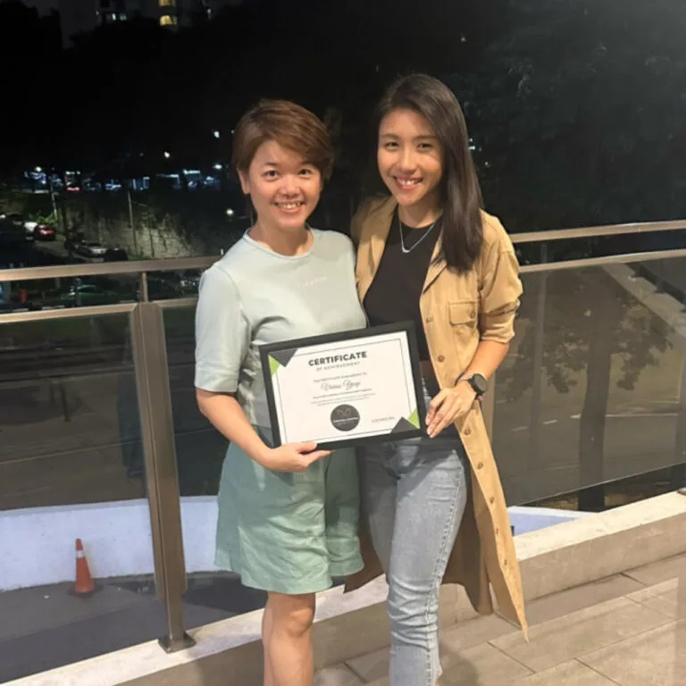 coach and female client with certificate standing